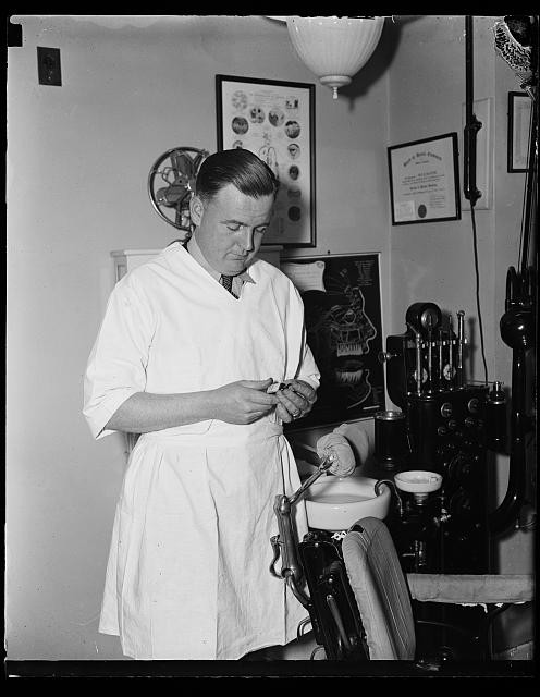 Photo:1930s Dentist in Dental Office Examining Instrument Photo