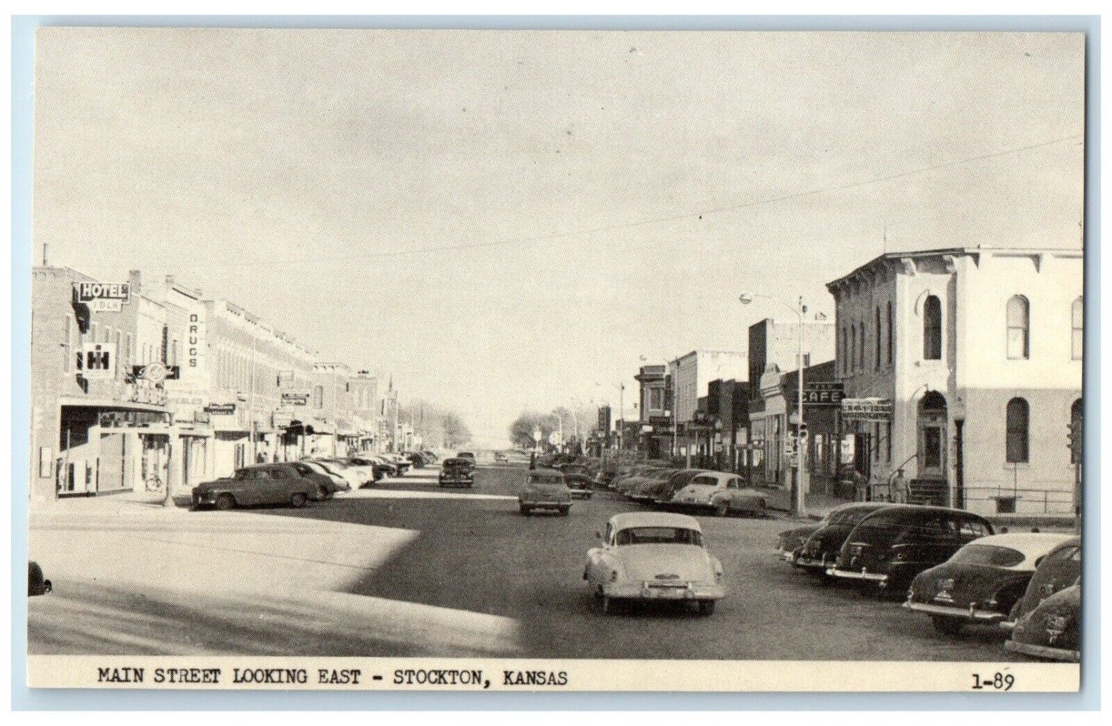 c1920 Main Street Looking East Exterior Building Cars Stockton Kansas Postcard