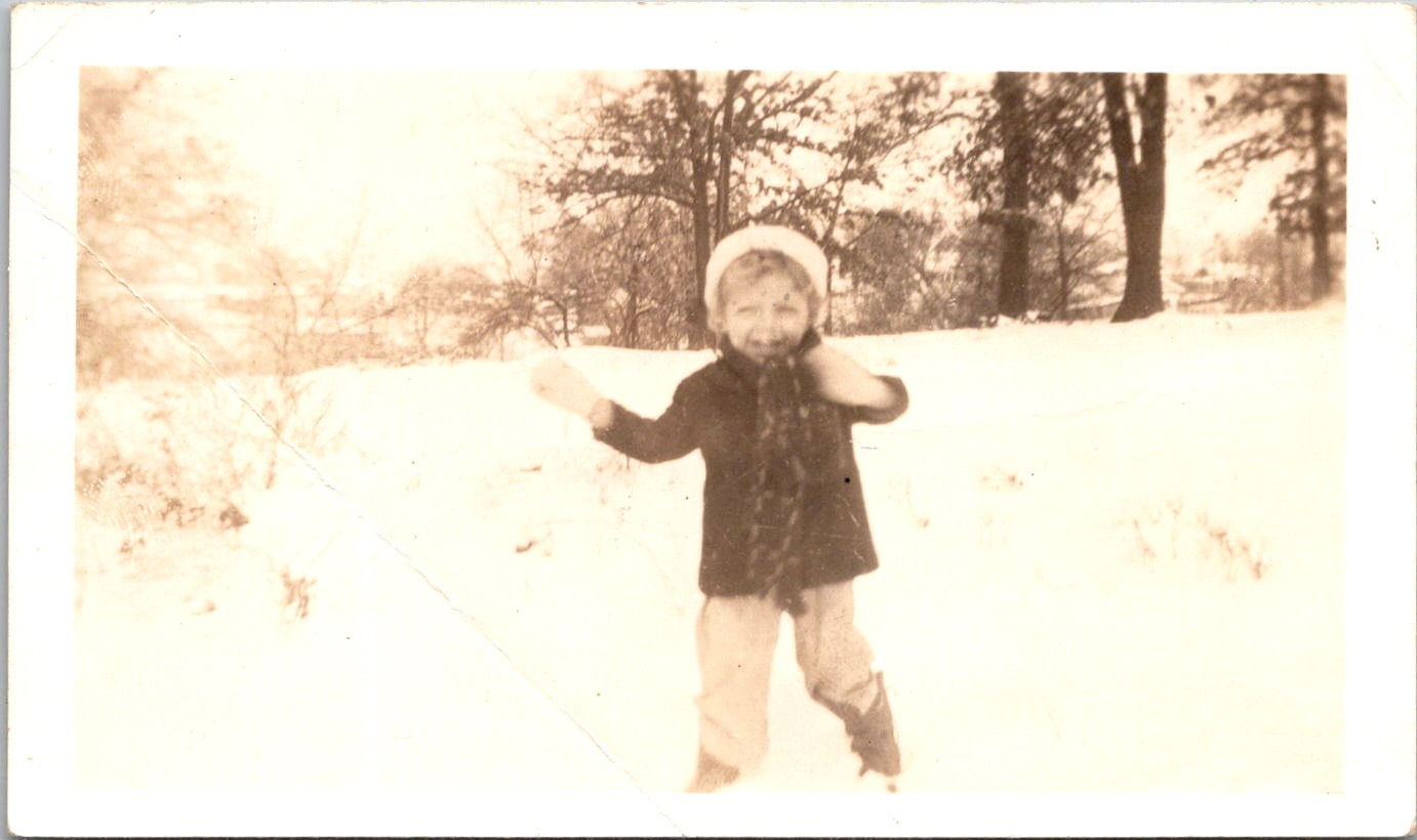 Happy Child Playing in the Winter Snow, 1930s Sepia Snapshot Photo