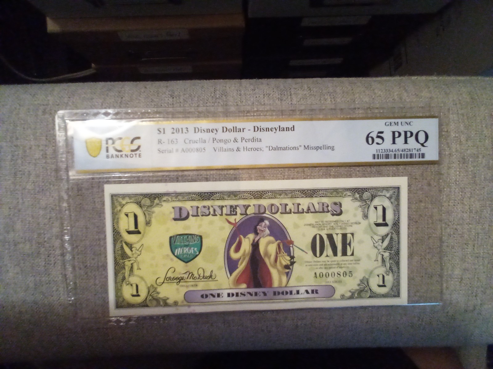 Disney Dollars 2013 $1 Cruella (Missprint) PCGS 65. GEM UNC 3 digit Ser no