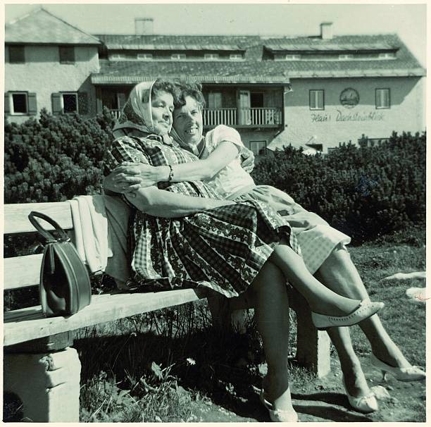 Two women traditional costume sitting sun Photograph Around 1960 Old Photo