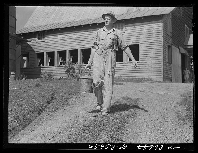 Photo:Farm Worker Carrying Bucket Barn Rural 1930s-1940s Male Laborer