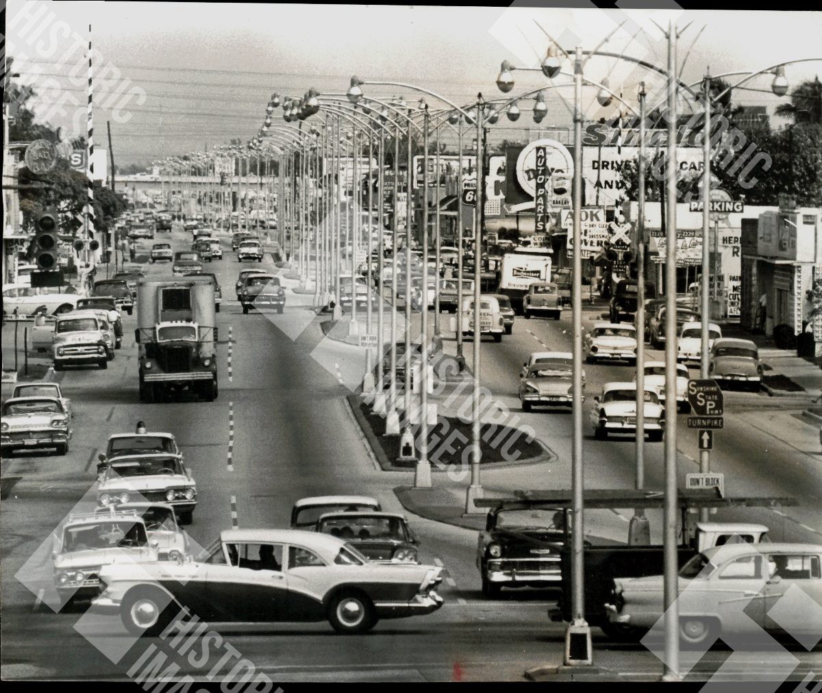 1963 A busy street with many cars and street lights