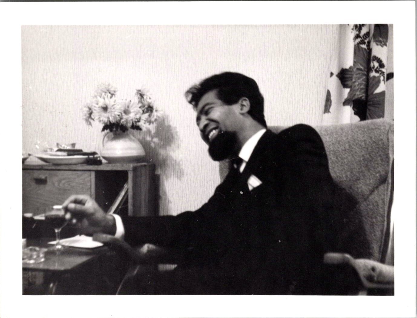 Vtg B&W Snapshot Smiling Man Beard Suit Holding Drink Armchair Interior 1960s