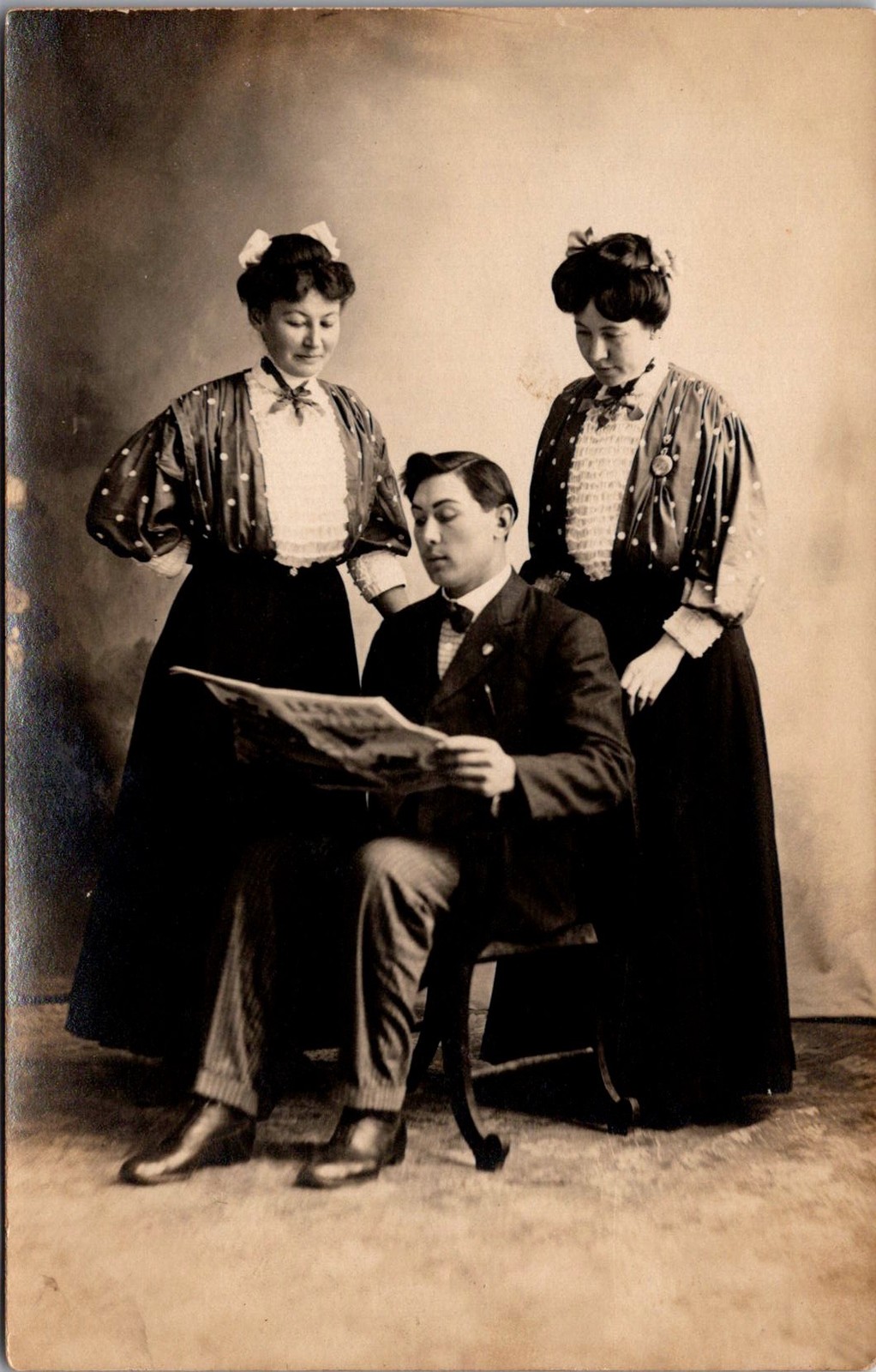 RPPC Man Reading Newspaper Two Women Studio Portrait Vintage Postcard 4P24-30 RPPC Man Reading Newspaper Two Women Studio Portrait Vintage Postcard 4P24-30