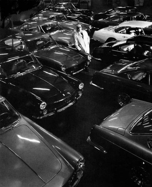 The Italian entrepreneur driver Enzo Ferrari posing among cars Ita- Old Photo