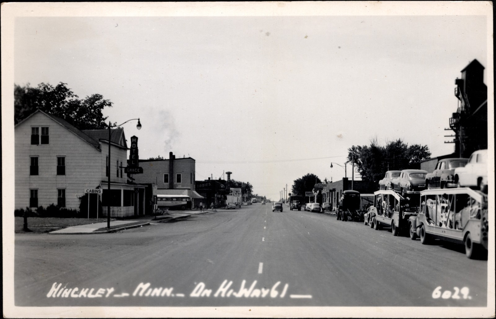 Hinckley MN HiWay 61 with Car Carriers & New Cars ca. 1950 RPPC Hamilton Photo