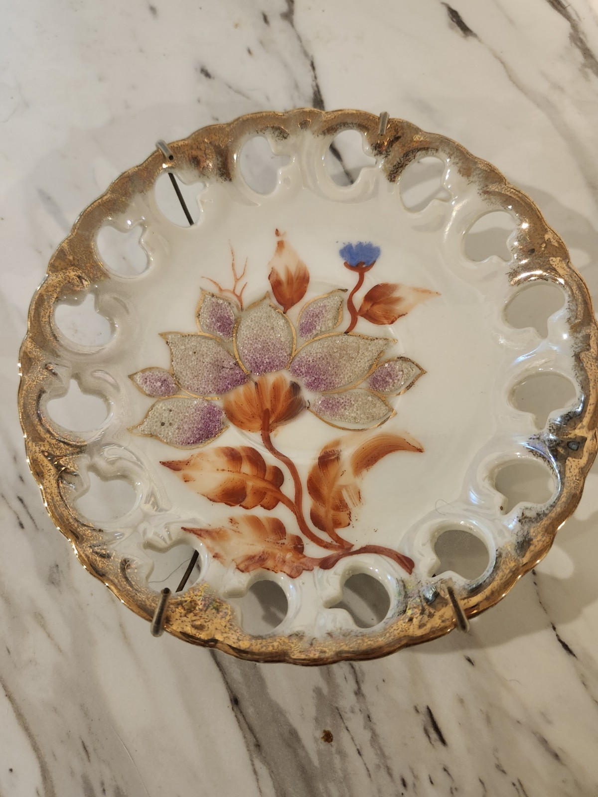 Handpainted ceramic plate with reticulated, gilded rim, plate wall decor
