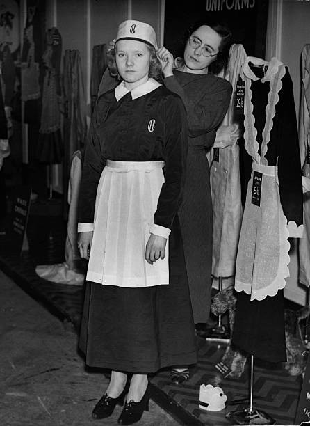 Young woman is dressed a servants uniform Domestic Services Exhibi- Old Photo