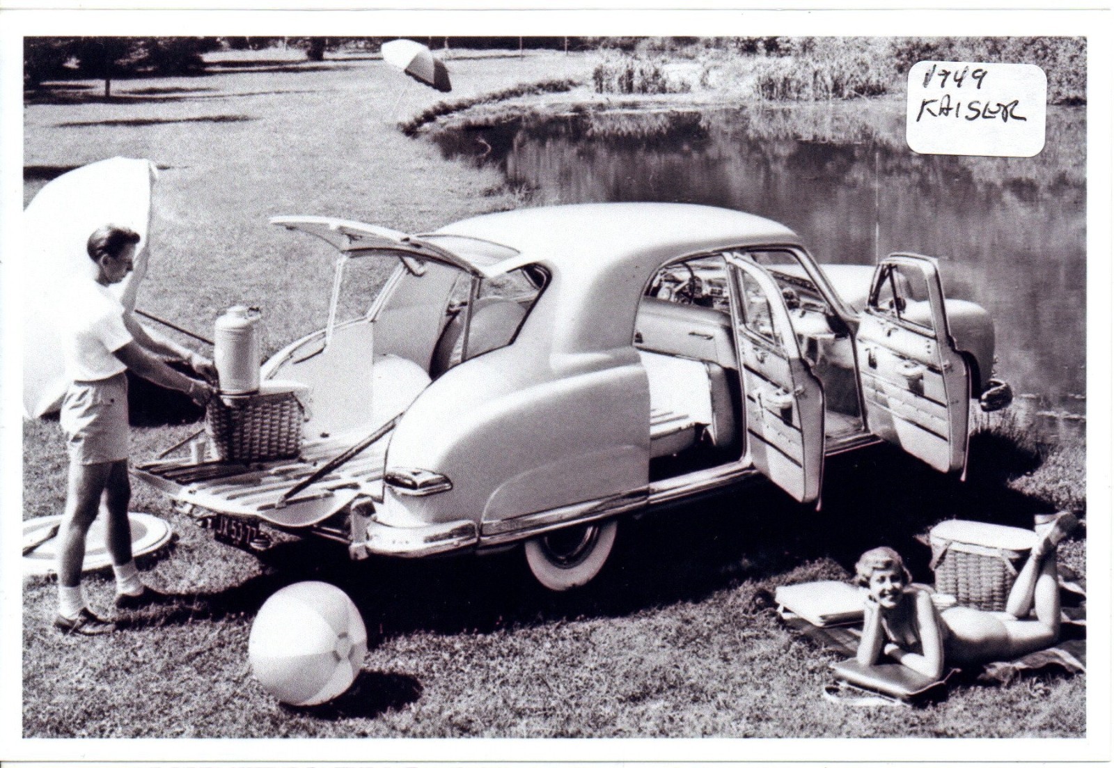 People Camping with 1949 Kaiser Automobile Photo