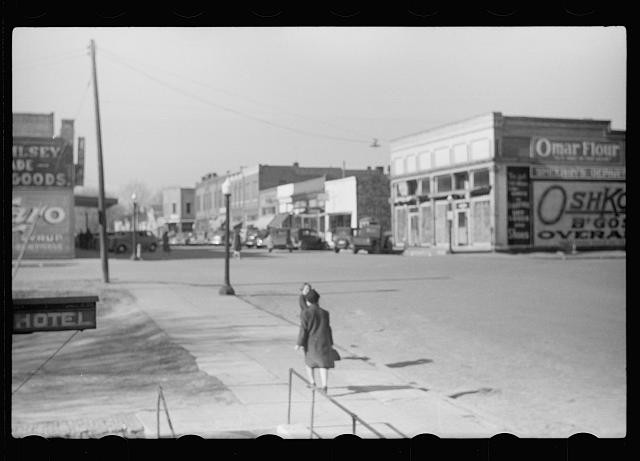 Photo:1930s Downtown Street Scene Storefronts Hotel Woman Walking