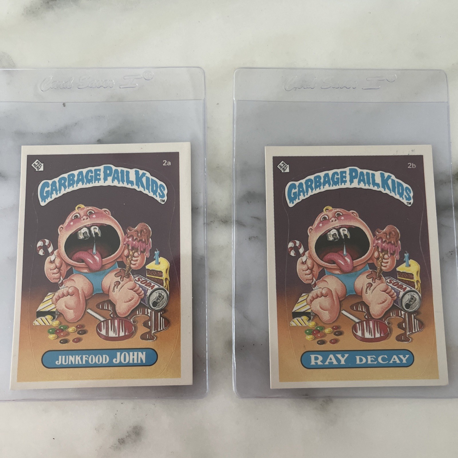 NM 1st 1 Garbage Pail Kids OS1 #2a Junkfood John 2b RAY DECAY GLOSSY PACK FRESH