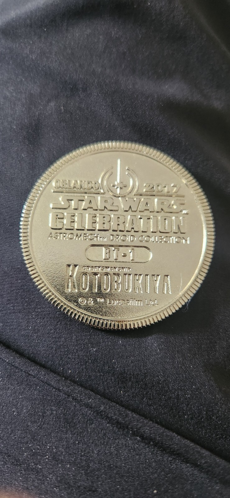 AI Overview+3a collectible coin commemorating the 2017 Star Wars Orlando