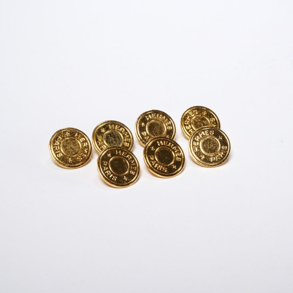 Set of Seven Gold Tone Hermés Paris Circular Shank Buttons