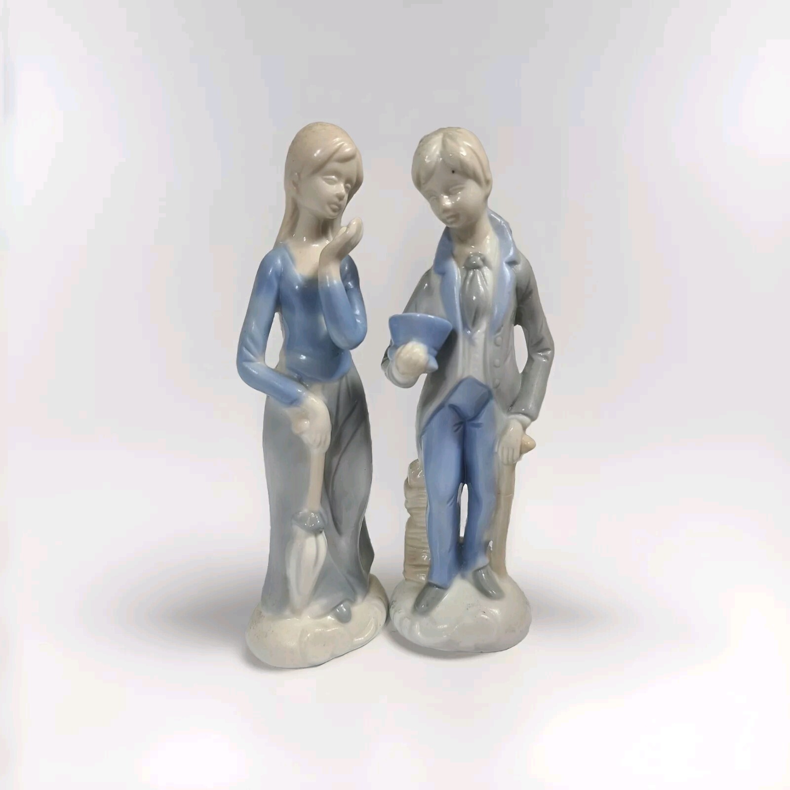 Porcelain Llarado like figurines girl w umbrella blowing kiss boy w top hat