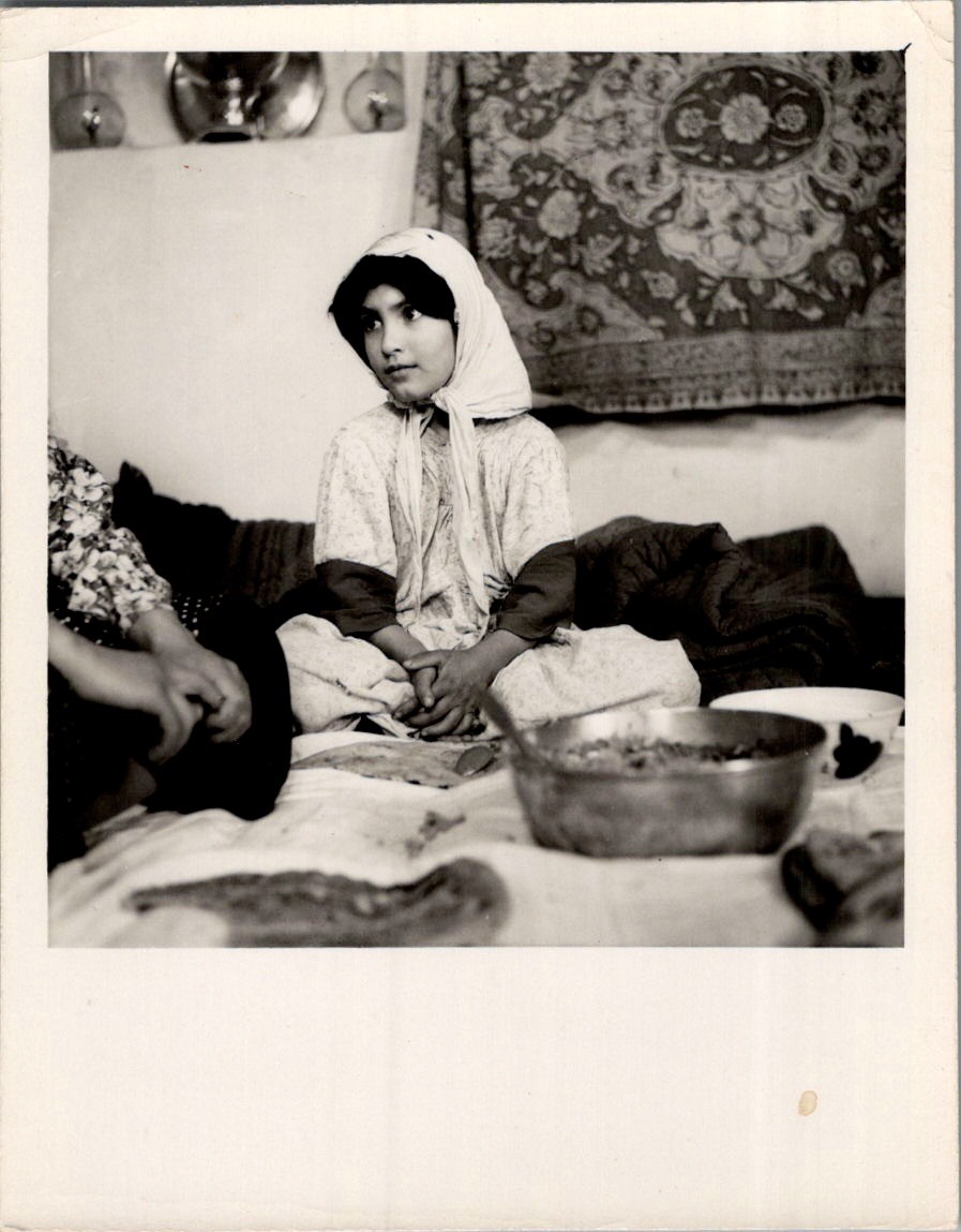 ~1950s Photograph Girl Seated at a Floor Meal, Suggests Iran