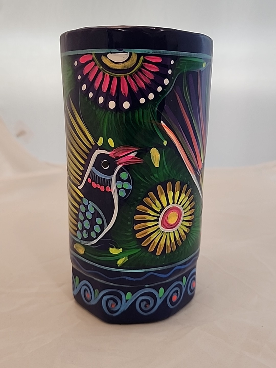 This vintage Mexican mug is a unique piece of pottery with a hand-painted design