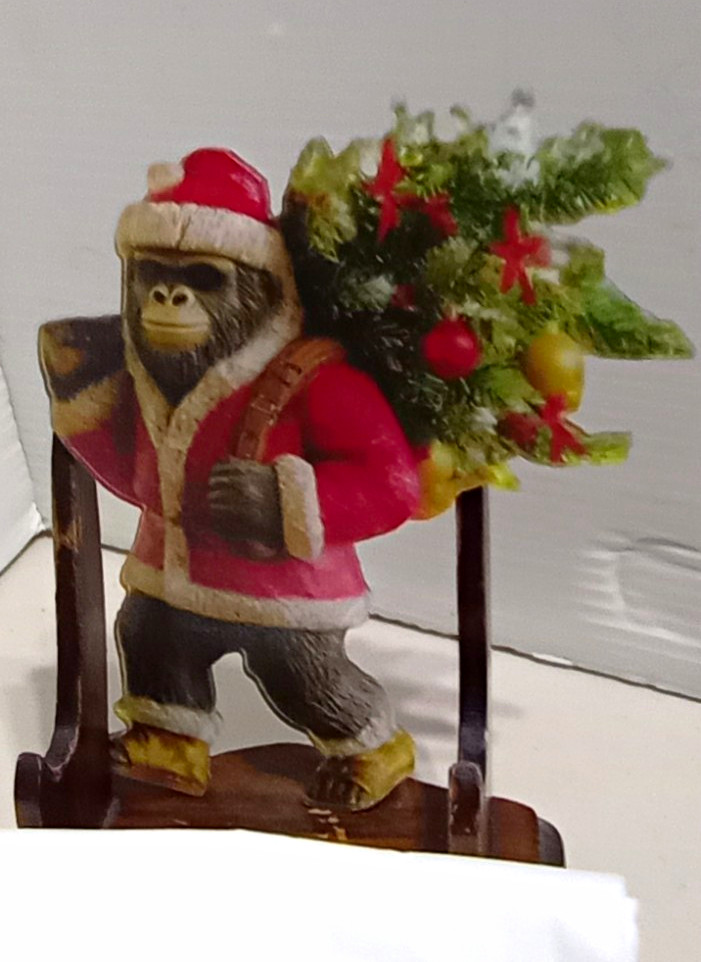 Sasquatch Christmas Ornament Dressed as Santa carrying a Tree