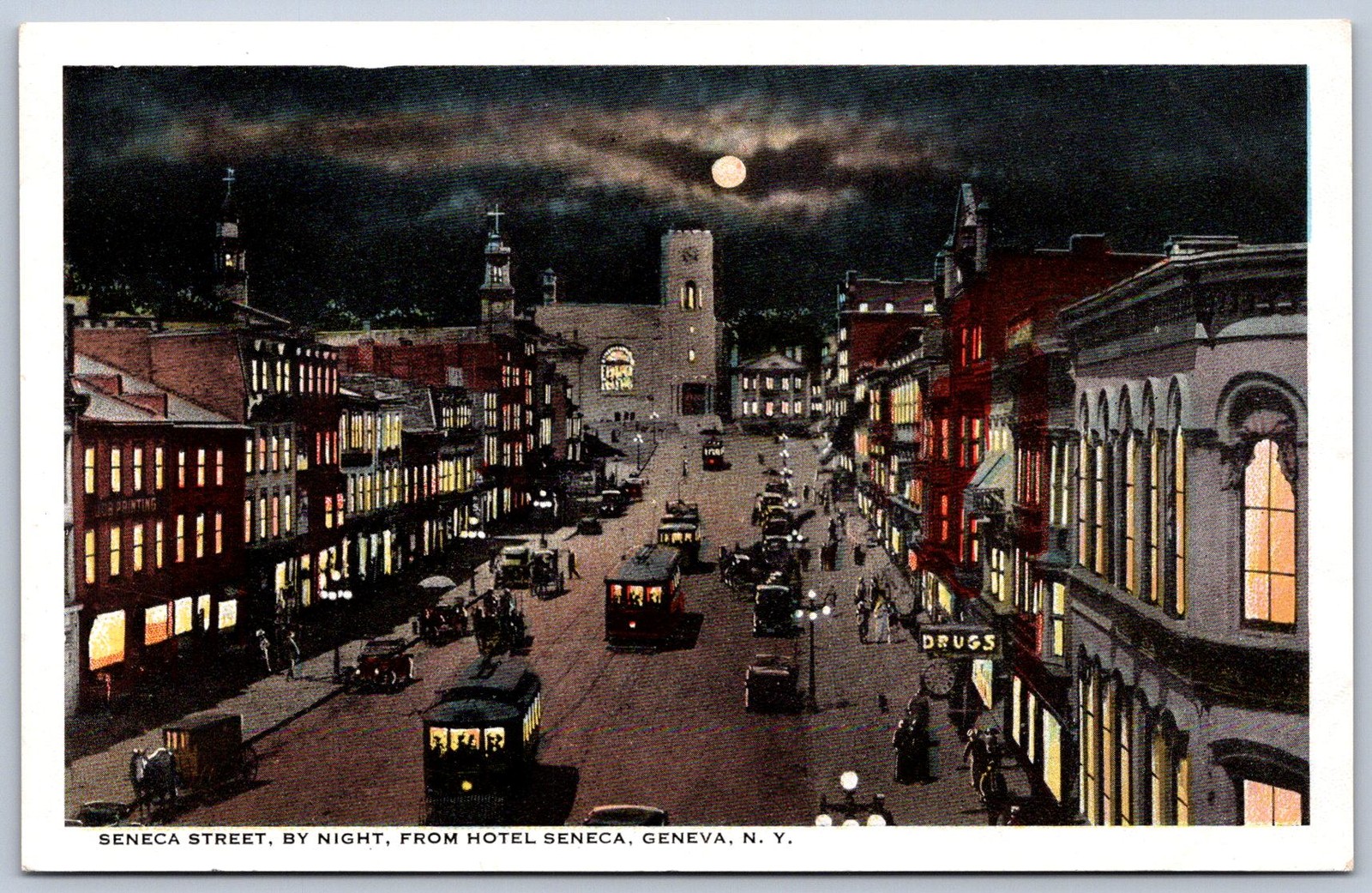 K38/ Geneva New York Postcard c1915 Seneca Street Stores Night 434
