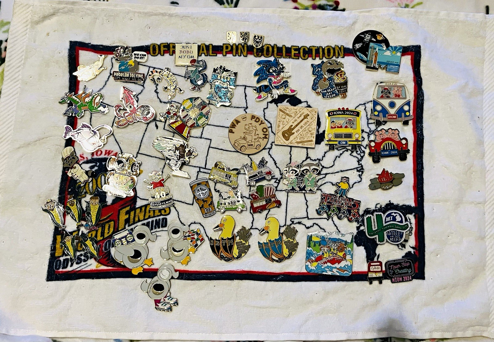 Odyssey of the Mind OOTM HUGE Pin Lot on Pin Towel 50+ Pins Some Complete Sets