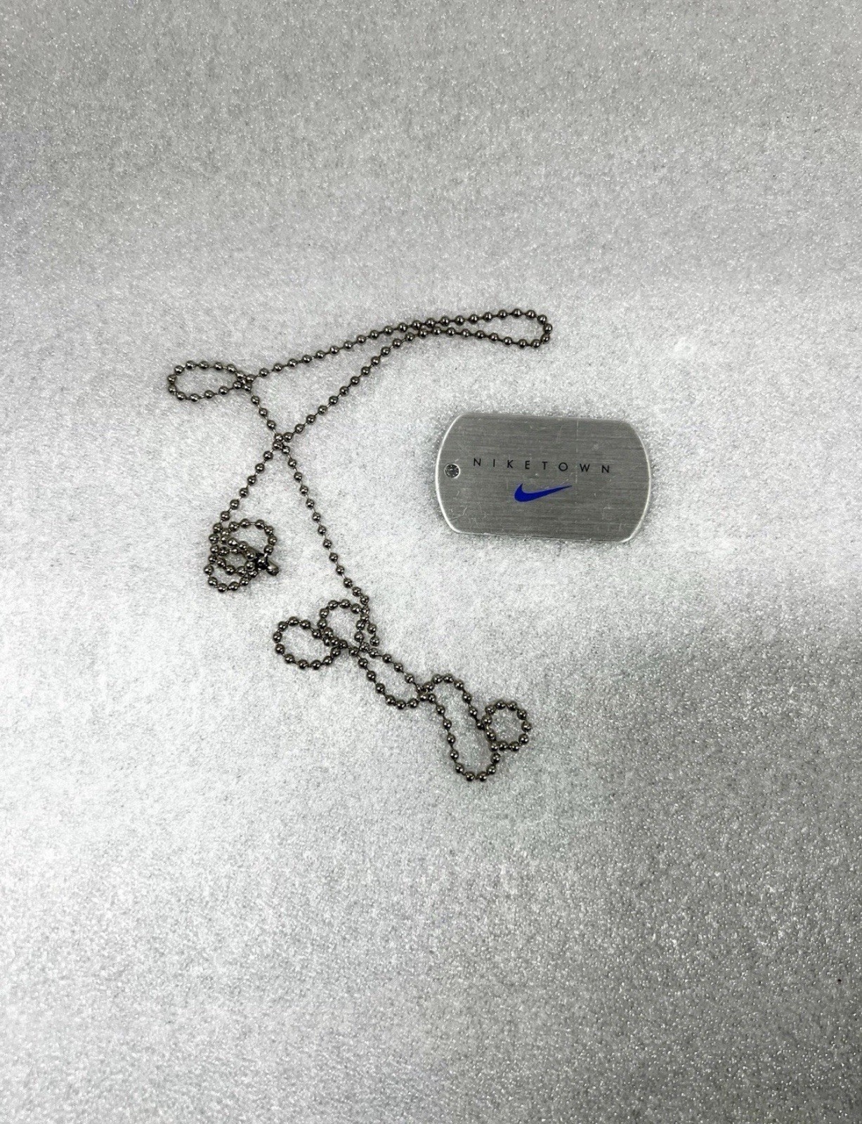 Vintage NIKE dog tag specifically a promo item from flagship \