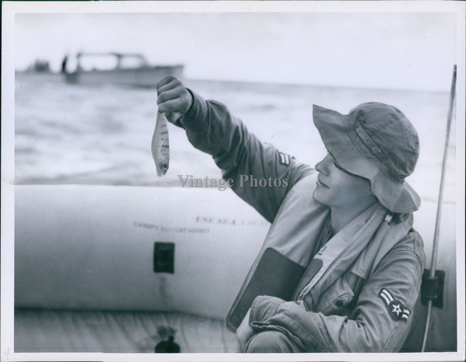 1956 Man In Raft Holding Up Small Fish Smiling Wearing Hat Vintage Photo 6x8