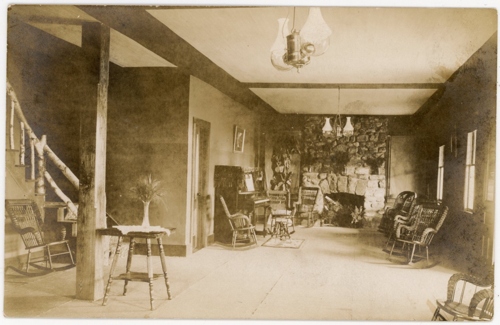 Rustic Lodge Interior Stone Fireplace Wicker Rockers Log Staircase RPPC c1910