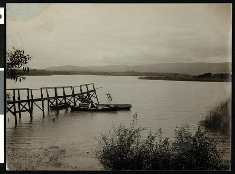 Man In A Boat Near A Dock On Laguna Granda Or College Lake In Wat - Old Photo