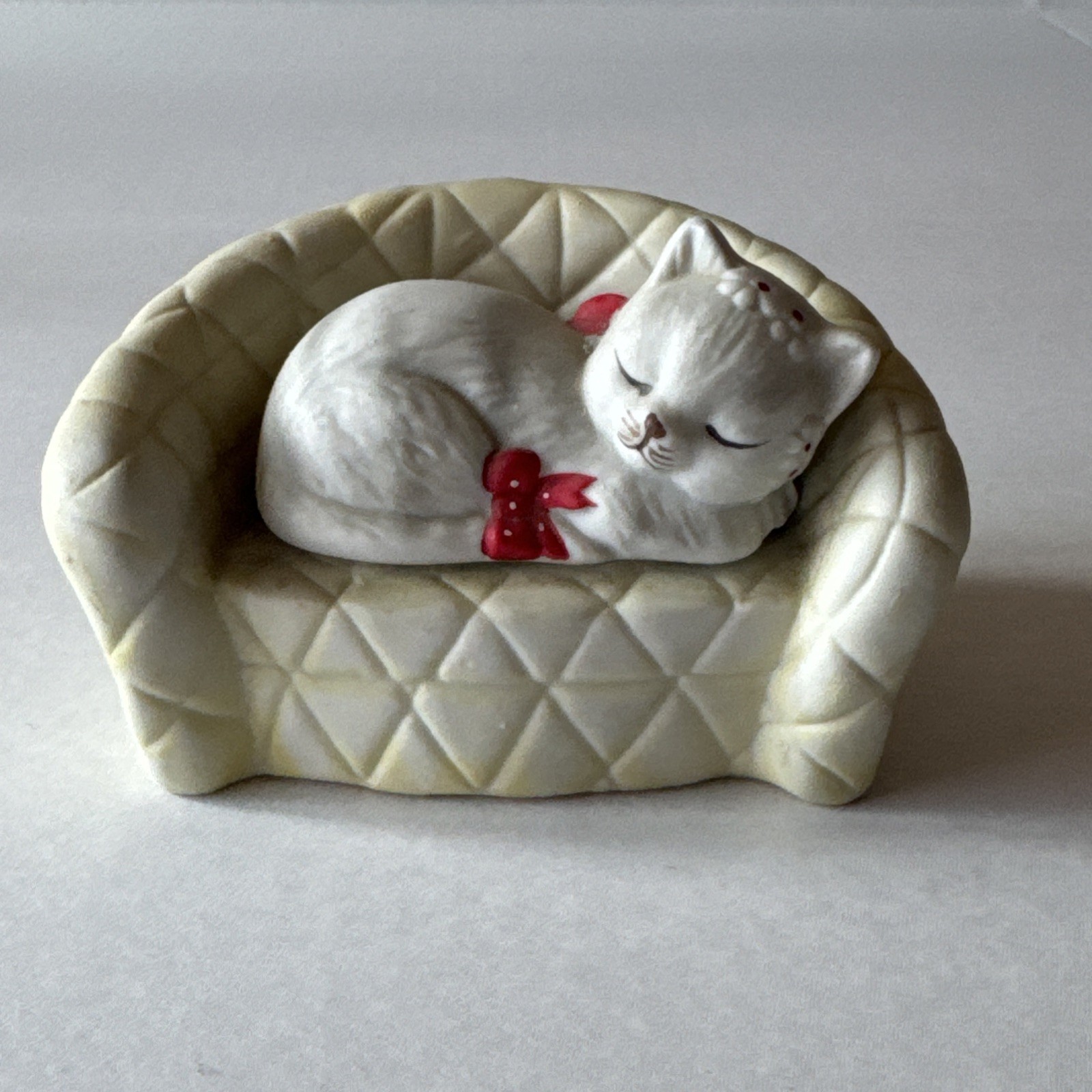 Porcelain Bisque Sleeping Kitty on a Couch/Sofa Figurine 