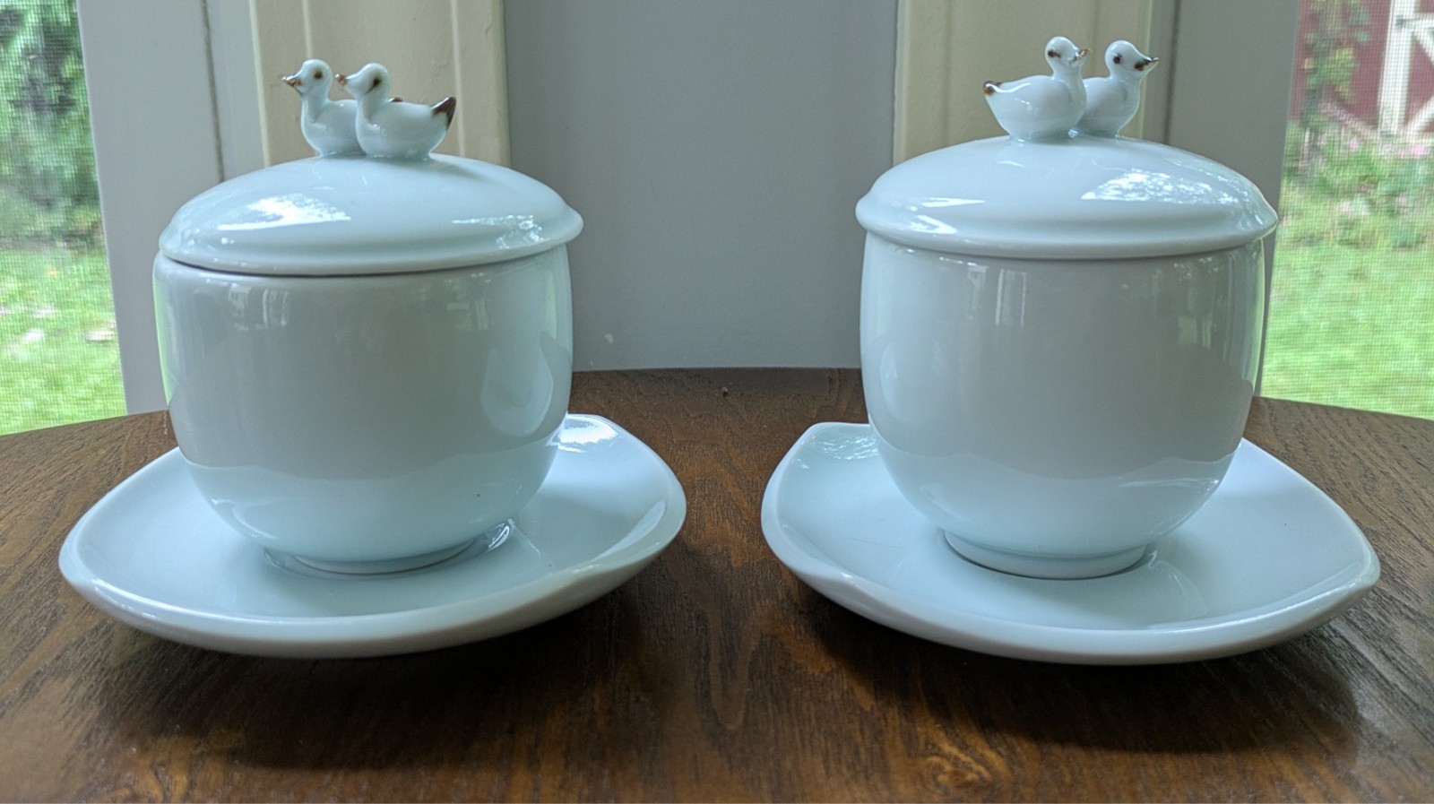 Vtg pair of Japanese celadon lidded tea cups & saucers, with twin duck finial