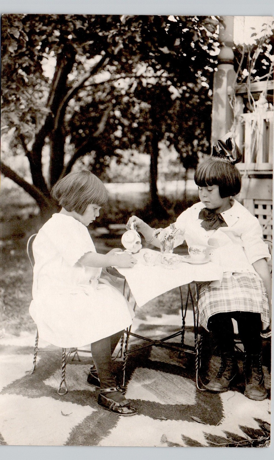 TWO LITTLE GIRLS TEA PARTY 1910s postcard real photo rppc home family home