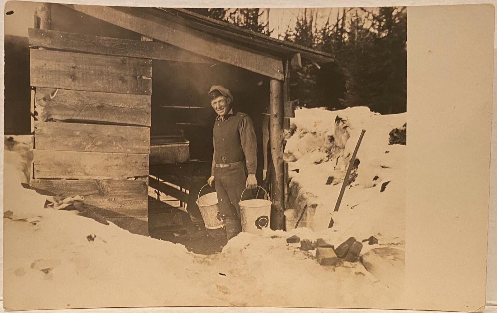 Real Photo Man Near Shed Carrying Two Buckets In Snow RPPC Postcard Farmer