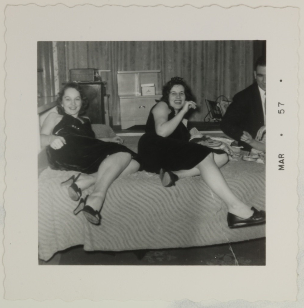 FOUND PHOTO - Two girls at a party showing off legs on bed 1950s FOUND PHOTO - Two girls at a party showing off legs on bed 1950s