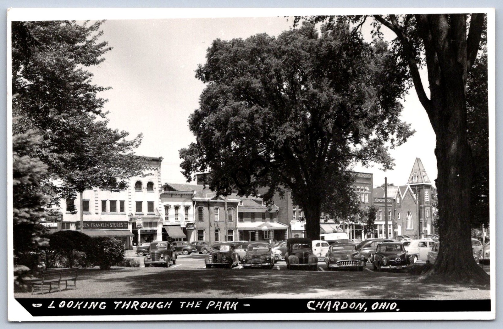 K38/ Chardon Ohio RPPC Postcard c1950s Looking Through Park Stores 508