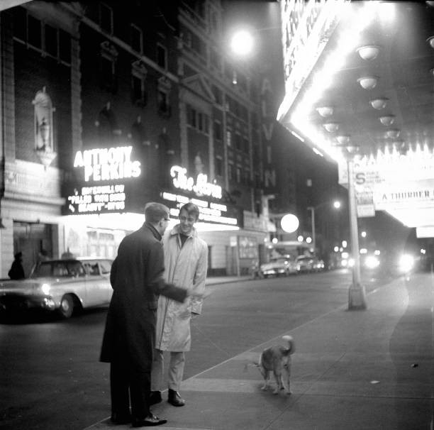 Nighttime view of dancer actor Grover Dale talks an unidentified m- Old Photo