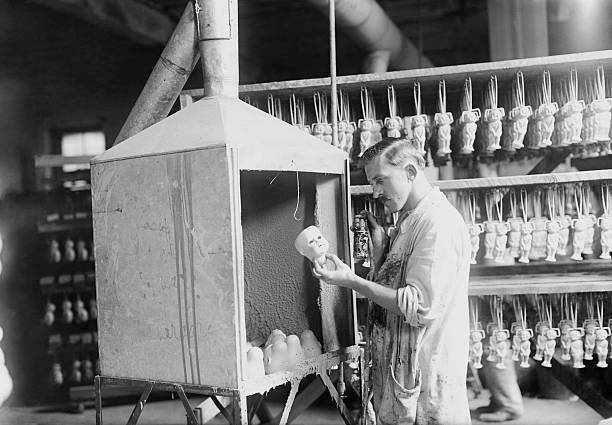 Worker checks porcelain doll heads after they were fired a kil- 1919 Old Photo