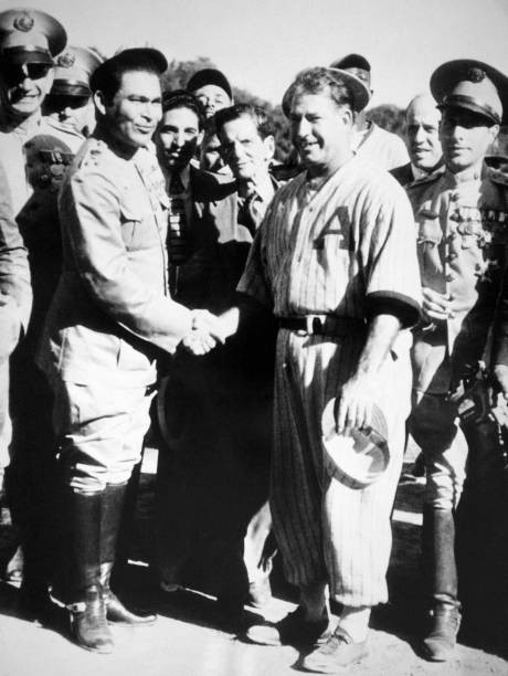 Cuban General Fulgencio Batista shakes hands Adolpho Luque coach - 1937 Photo