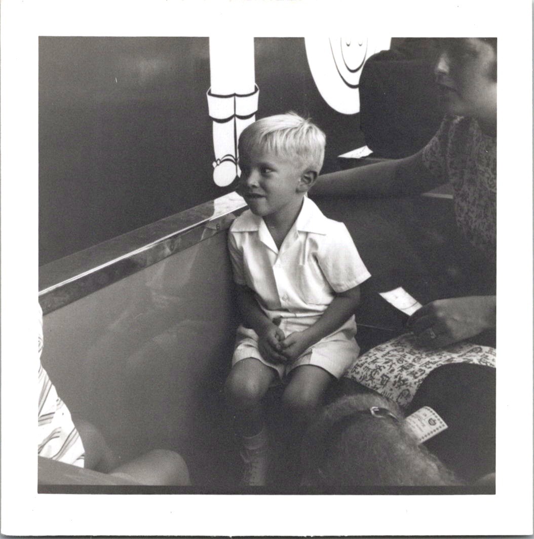 Young Blonde Boy Seated on Theme Park Ride, 1960s B&W Snapshot Photo