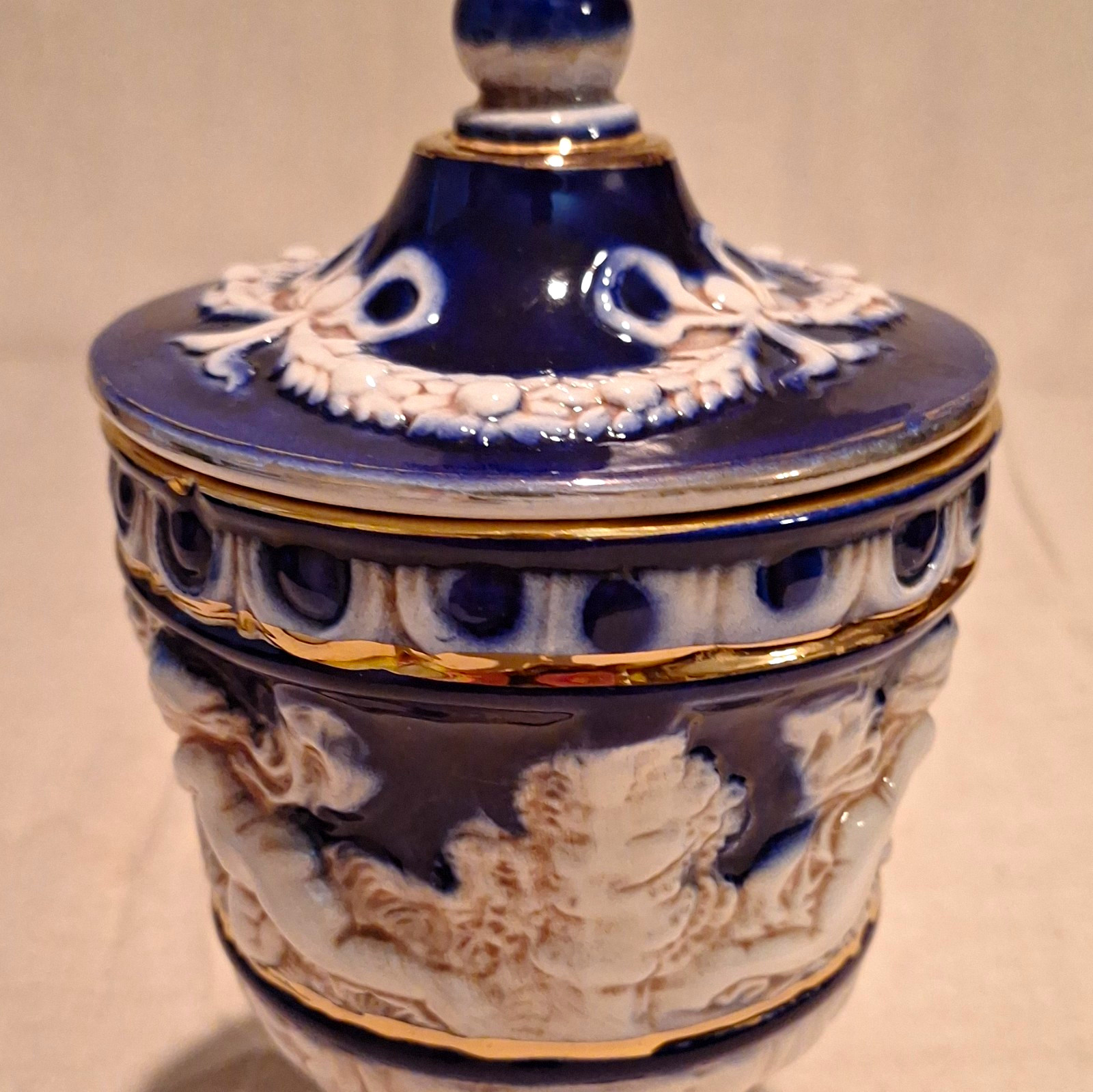 Blue White Gold Ceramic Cherub Relief Lidded Jar, Italy, 1900-1919. 9.25