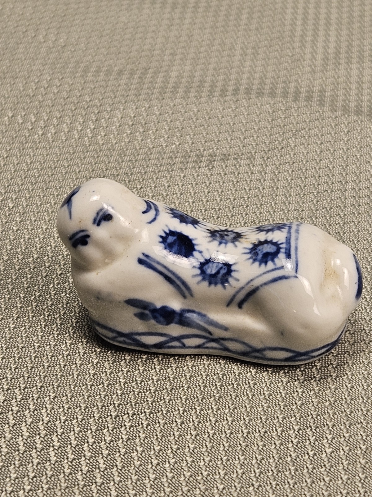 blue and white porcelain reclining Buddah chop stick rest.