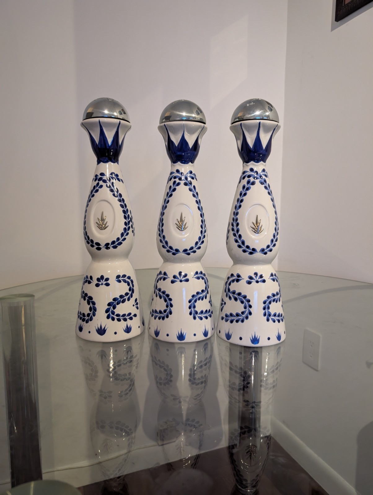 empty liquid bottles with its cases (Louis X111, The John Walker, Claze Azul)