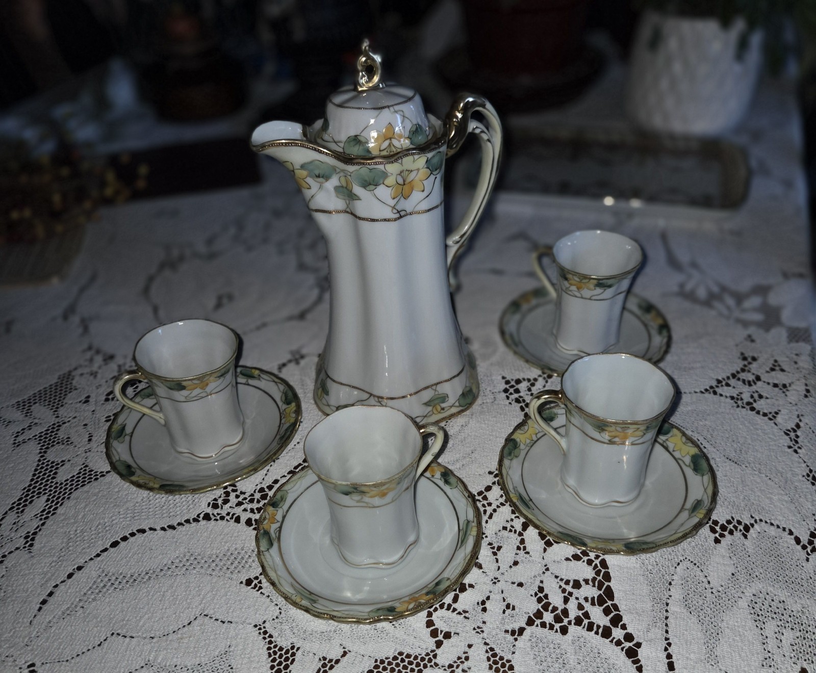 This is a Antique hand-painted porcelain Nippon chocolate pot set 