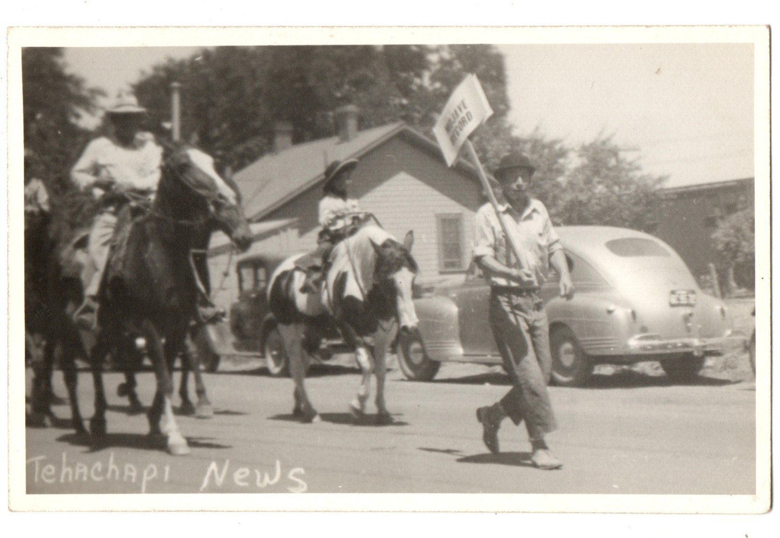 RPPC postcard TEHACHAPI CALIFORNIA PARADE man sign newspaper MOJAVE RECORD 1940s