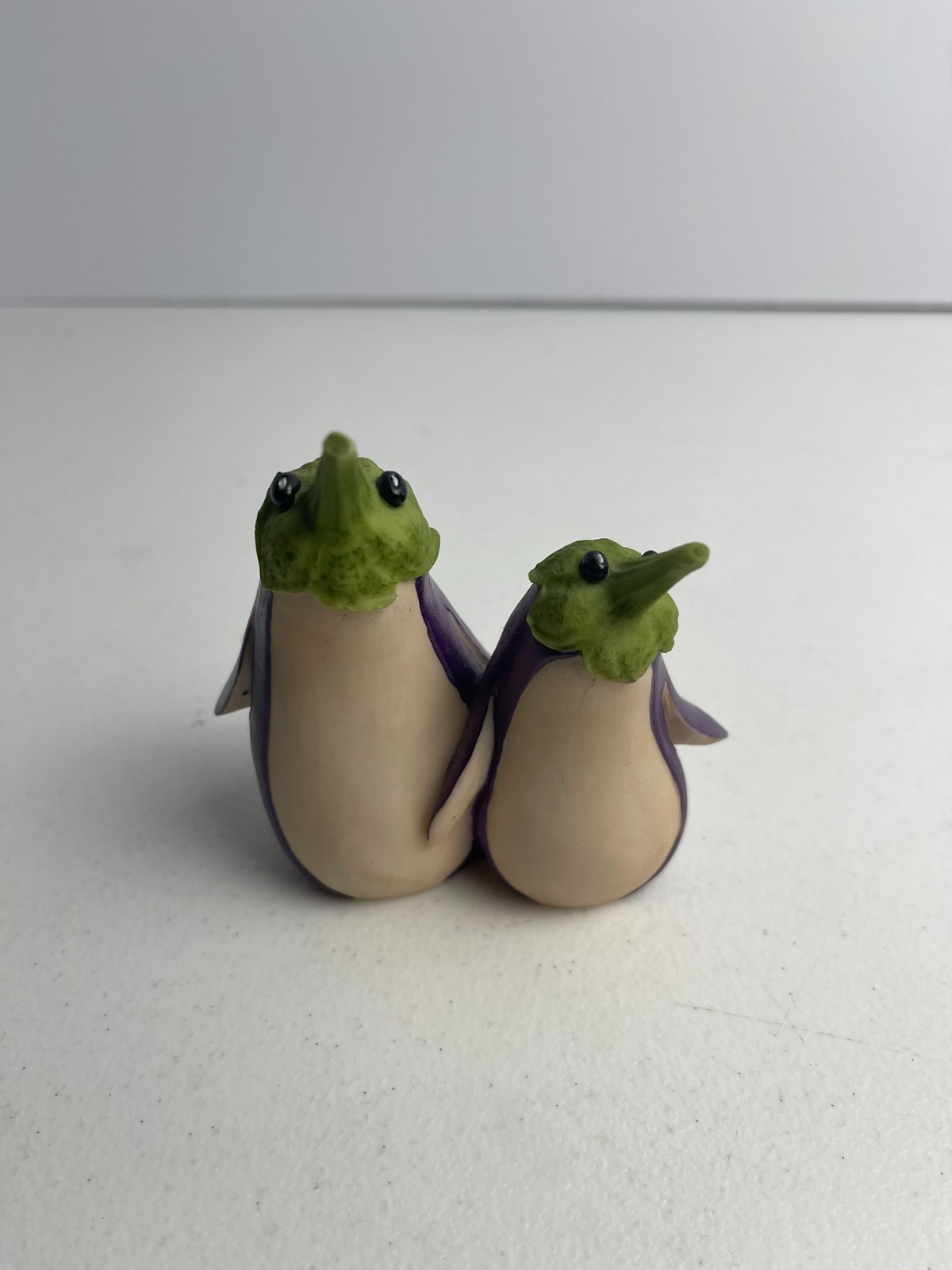 ENESCO HOME GROWN FIGURINE - EGGPLANT PENQUINS