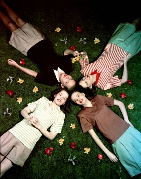 Overhead view looking down four young women laying grass a star fo- Old Photo