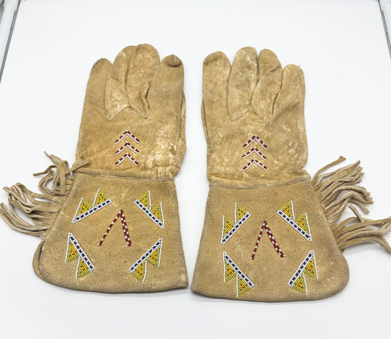 Pair of Northern Plains Indian Beaded Gauntlet gloves Early 20th century Pair of Northern Plains Indian Beaded Gauntlet gloves Early 20th century