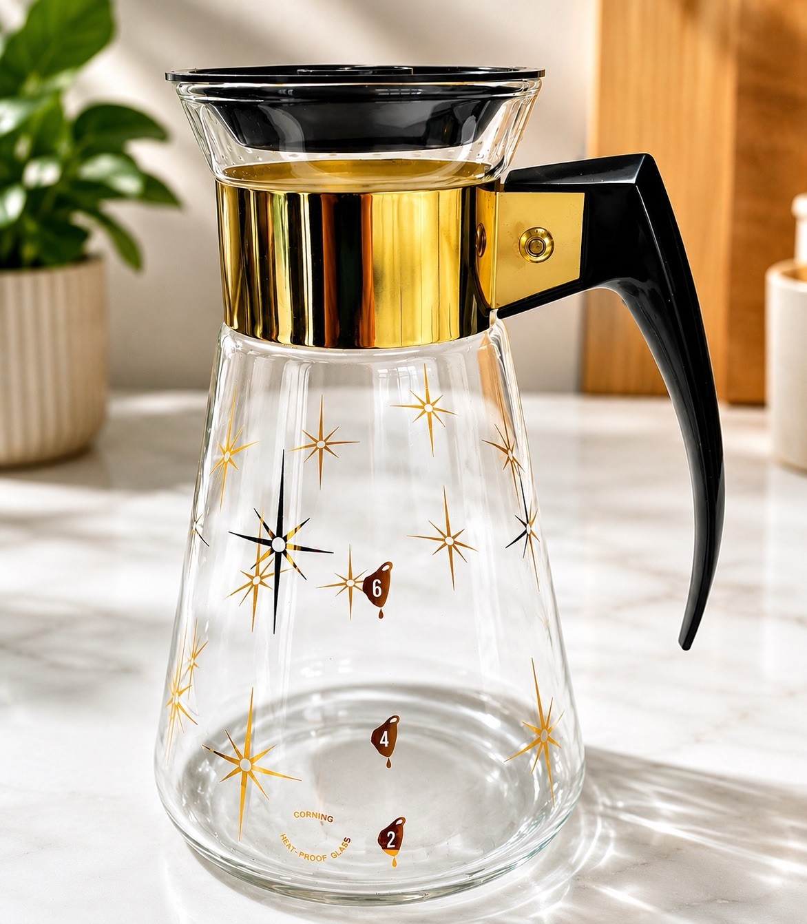 VTG CORNING WARE COFFEE CARAFE.  GOLD ATOMIC STARBURST PATTERN.  6 CUP. 8” TALL