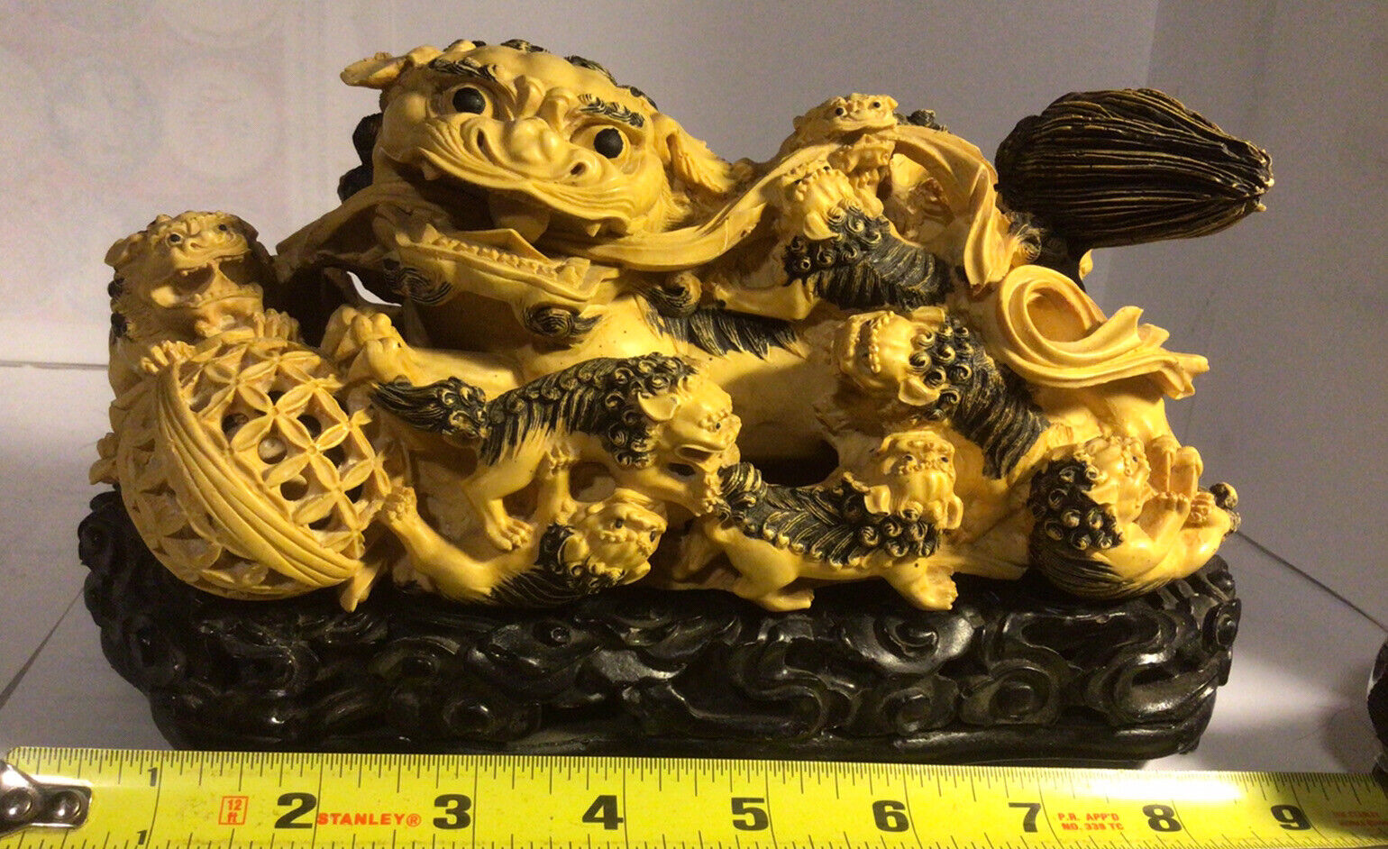 vintage reclining temple foo dog /dragon/lion with 8 children 8” L 4” H on stand