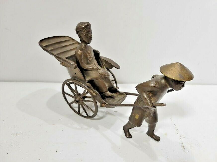Solid Metal Man Pulling Cart 