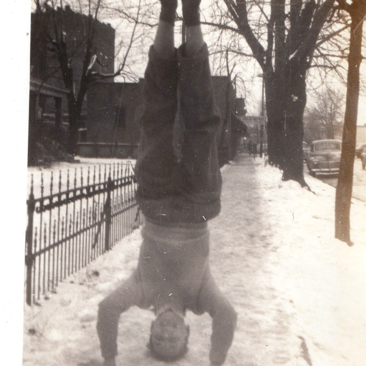 c1940s Boy Doing Headstand in Snow Sidewalk Snapshot Photo Fence Winter Cars Vtg c1940s Boy Doing Headstand in Snow Sidewalk Snapshot Photo Fence Winter Cars Vtg